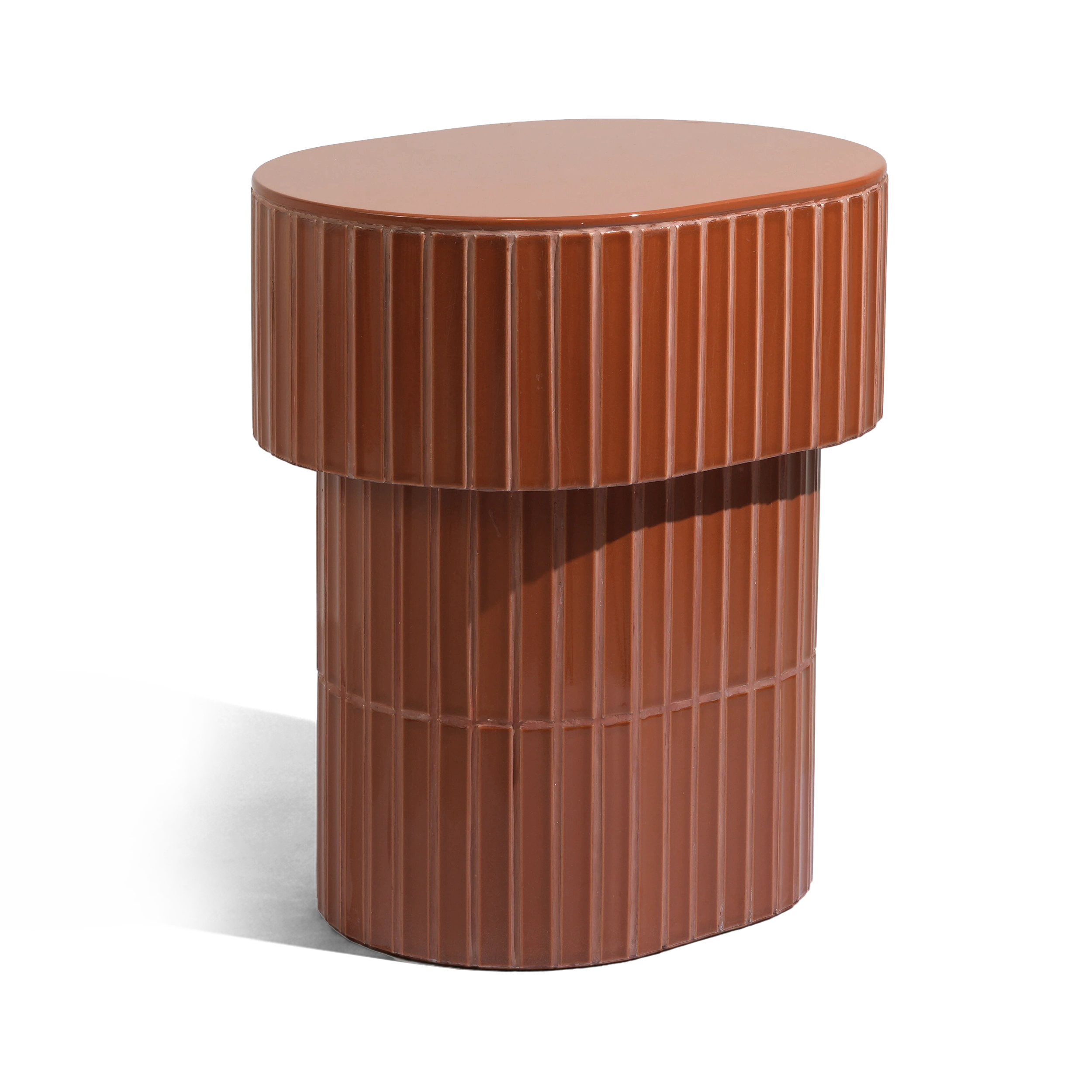 A modern oval side table or stool with a grooved ceramic tiled finish featuring a round top and a warm brown color, shown on a plain background.