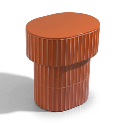 A modern oval side table or stool with a grooved ceramic tiled finish featuring a round top and a warm brown color, shown on a plain background.