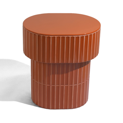 A modern oval side table or stool with a grooved ceramic tiled finish featuring a round top and a warm brown color, shown on a plain background.