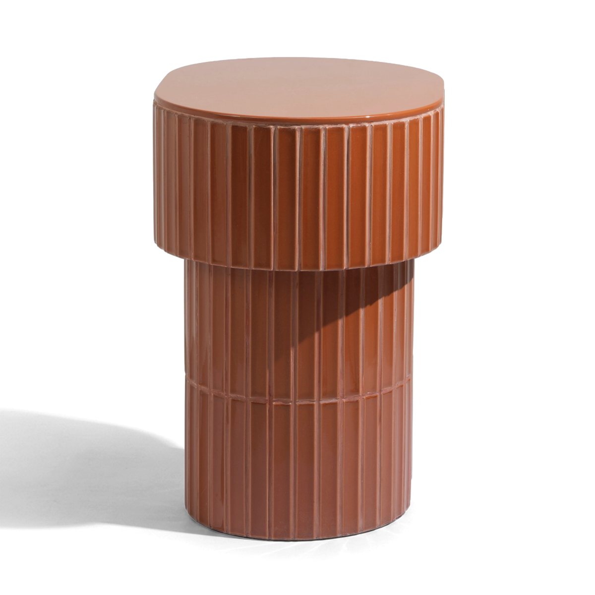 A modern oval side table or stool with a grooved ceramic tiled finish featuring a round top and a warm brown color, shown on a plain background.