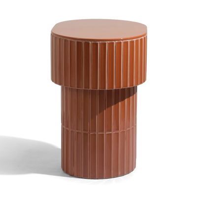 A modern oval side table or stool with a grooved ceramic tiled finish featuring a round top and a warm brown color, shown on a plain background.