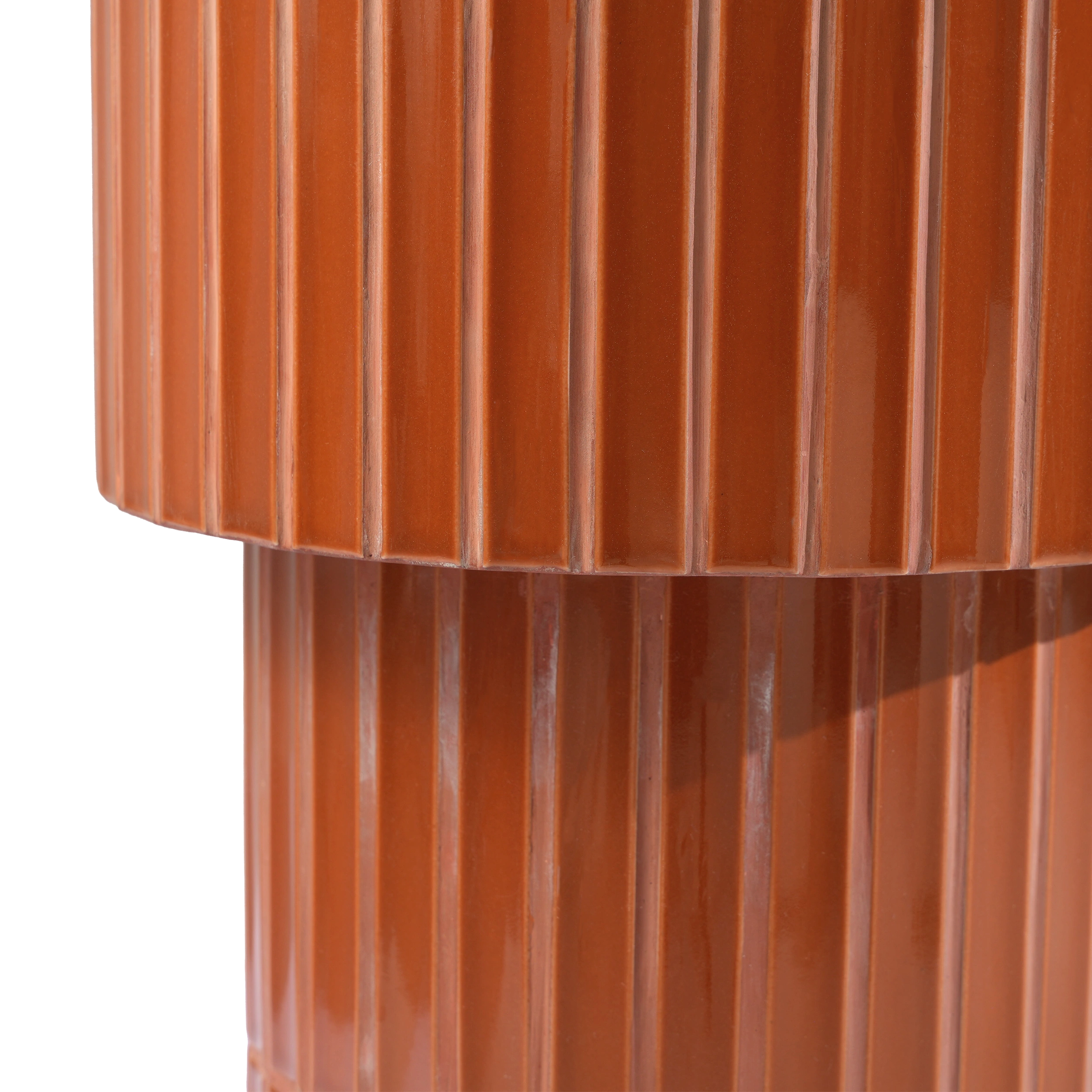 Close-up of a glossy brown tiled  oval end table, showing vertical grooves and a reflective finish against a plain background.