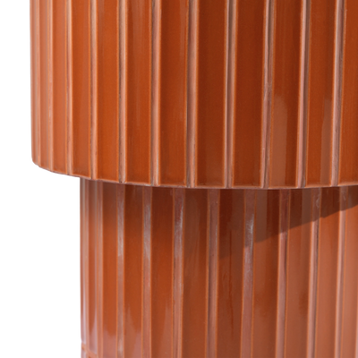 Close-up of a glossy brown tiled  oval end table, showing vertical grooves and a reflective finish against a plain background.