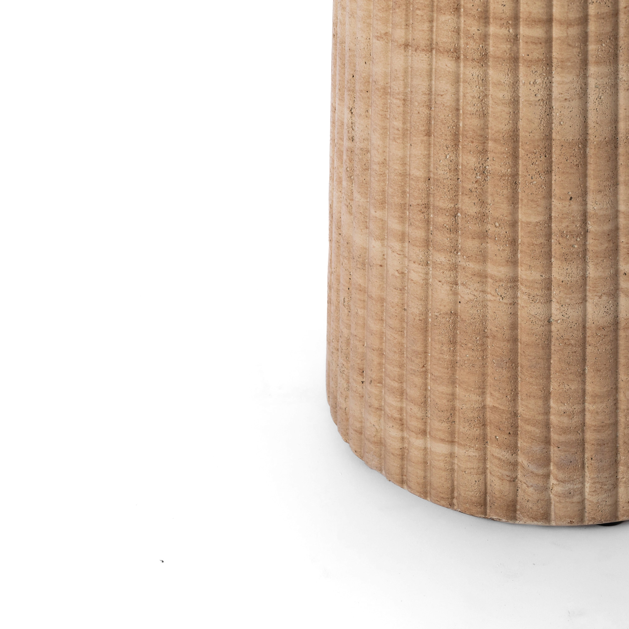 Close-up of a fluted round pedestal in a faux travertine finish, shown against a plain background. 