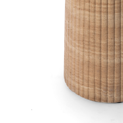 Close-up of a fluted round pedestal in a faux travertine finish, shown against a plain background. 